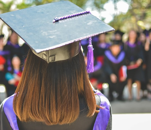 A woman wearing a graduation hat