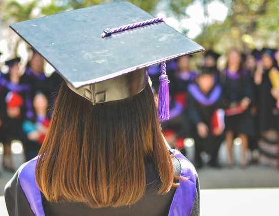 A woman wearing a graduation hat