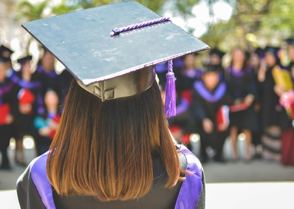 A woman wearing a graduation hat