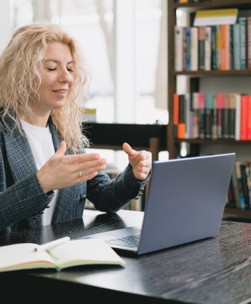 a woman video chatting in a library