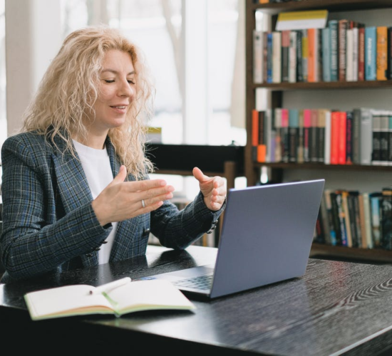 a woman video chatting in a library