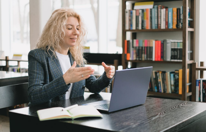 a woman video chatting in a library