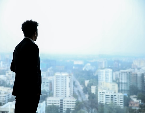 A businessman staring out of the window