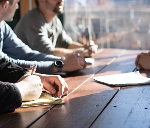 A group of people having a meeting together