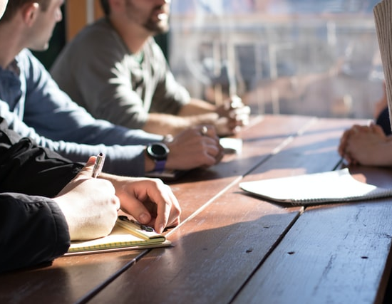 A group of people having a meeting together