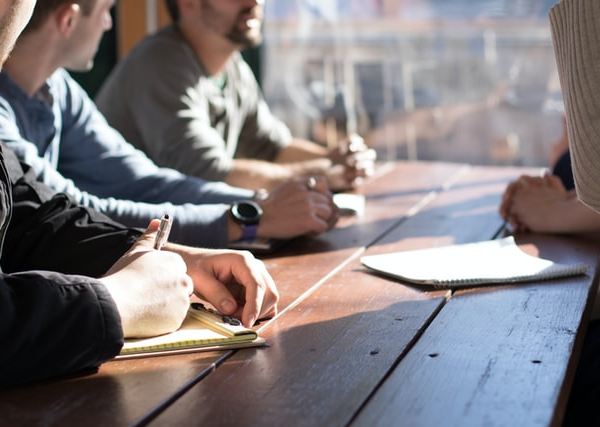 A group of people having a meeting together