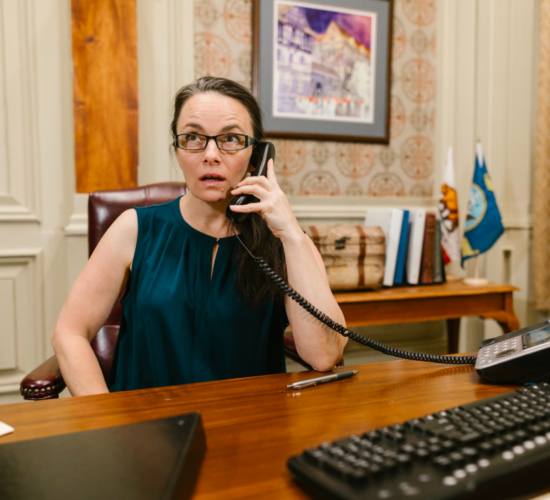 A lawyer works in her office, taking a call.