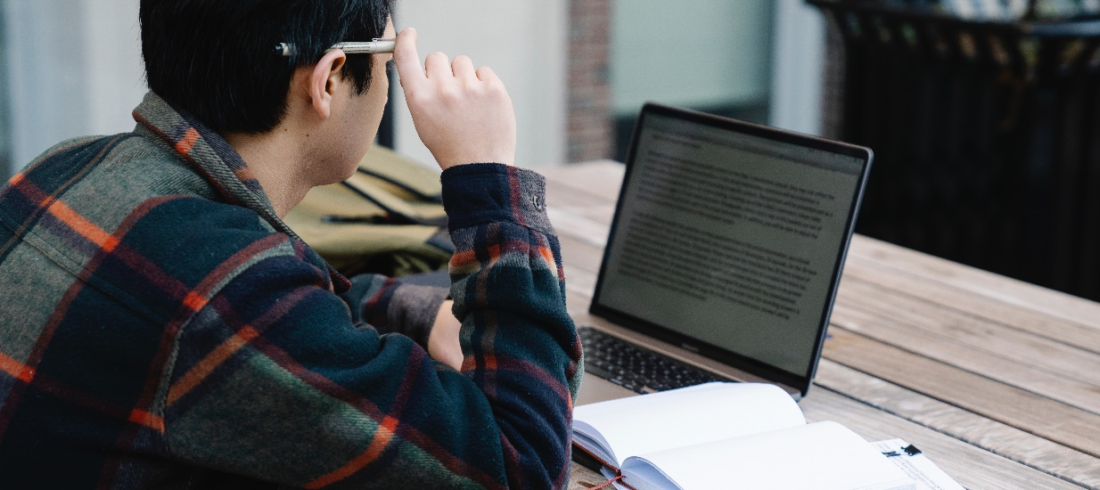 A man reading on his laptop