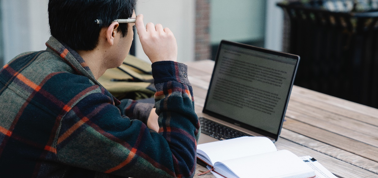 A man reading on his laptop