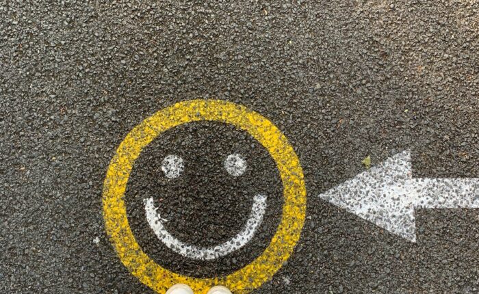 a drawing of a smiley face with an arrow pointing at it