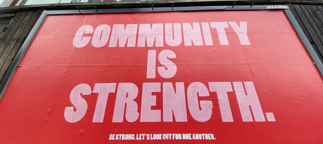 sign saying community is strength