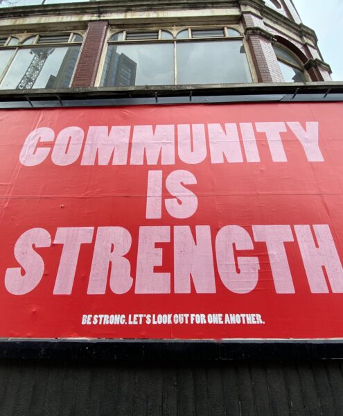 sign saying community is strength