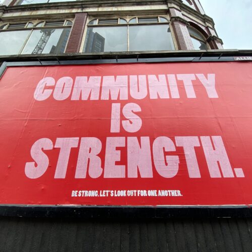 sign saying community is strength