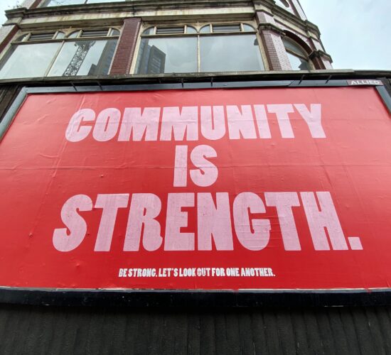 sign saying community is strength