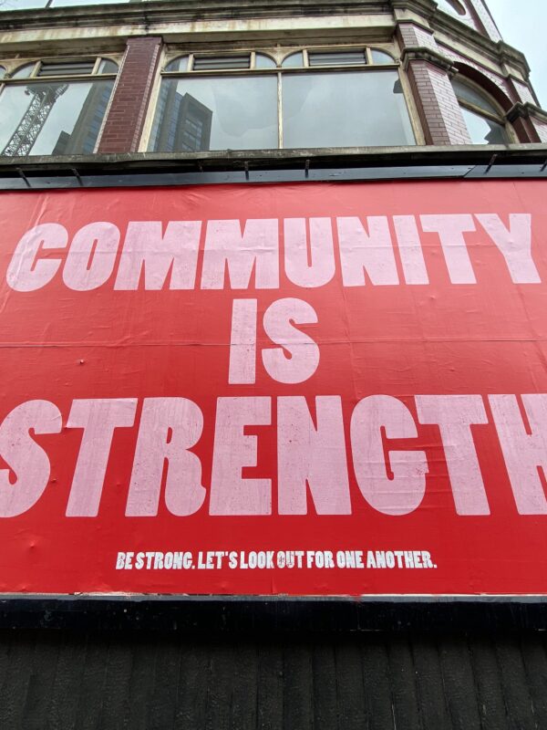 sign saying community is strength