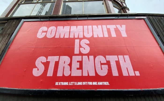 sign saying community is strength