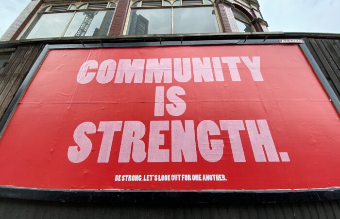 sign saying community is strength