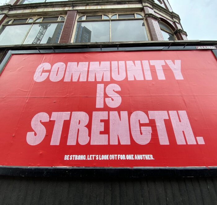 sign saying community is strength