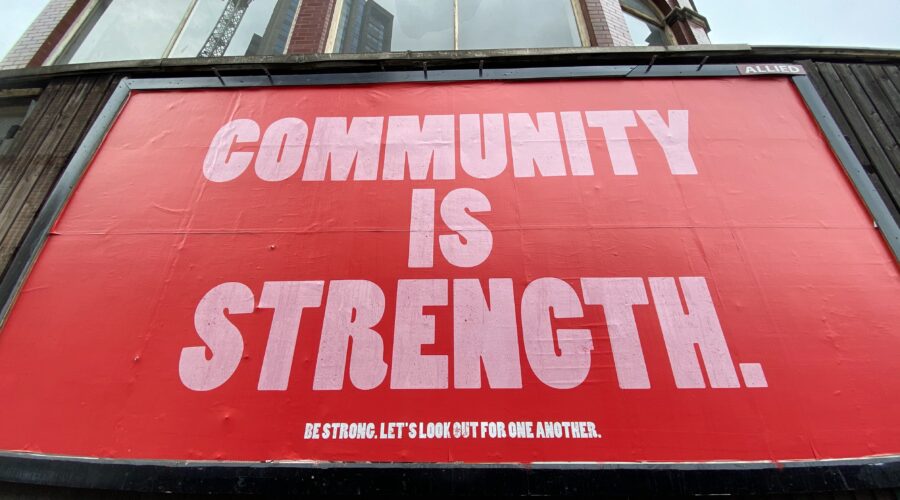 sign saying community is strength