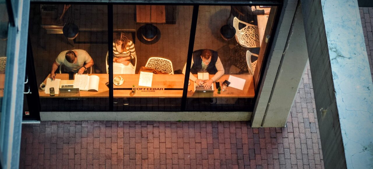 people working in a coffee shop; bird's eye view through the window