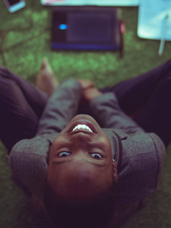 woman smiling at the camera, working on computer