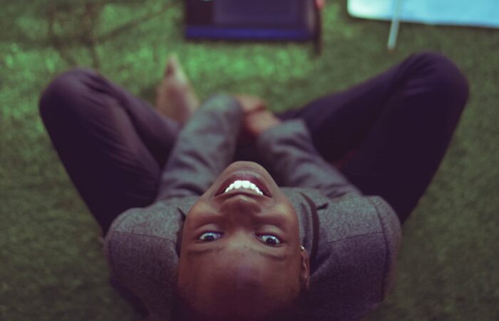 woman smiling at the camera, working on computer