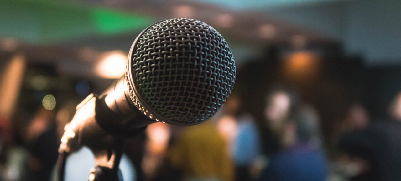motivational speaking class, microphone in front of a crowd