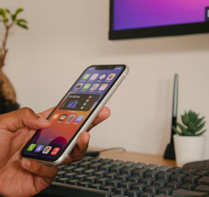 on phone in front of computer