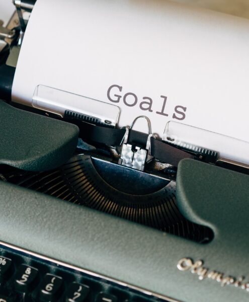 typewriter with paper that says "goals"