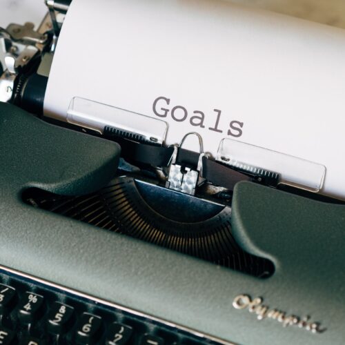 typewriter with paper that says "goals"