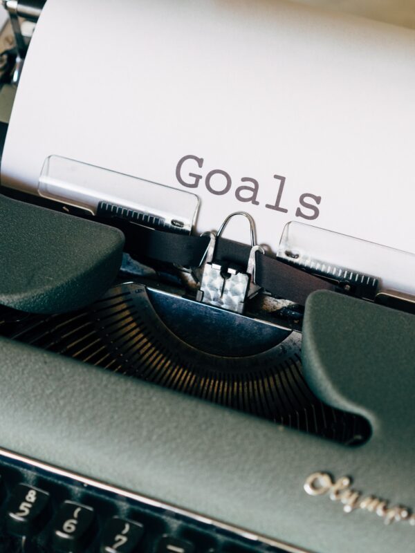 typewriter with paper that says "goals"