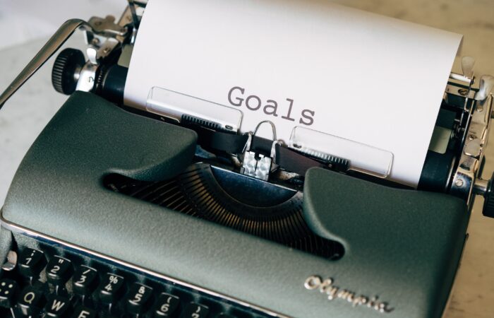 typewriter with paper that says "goals"