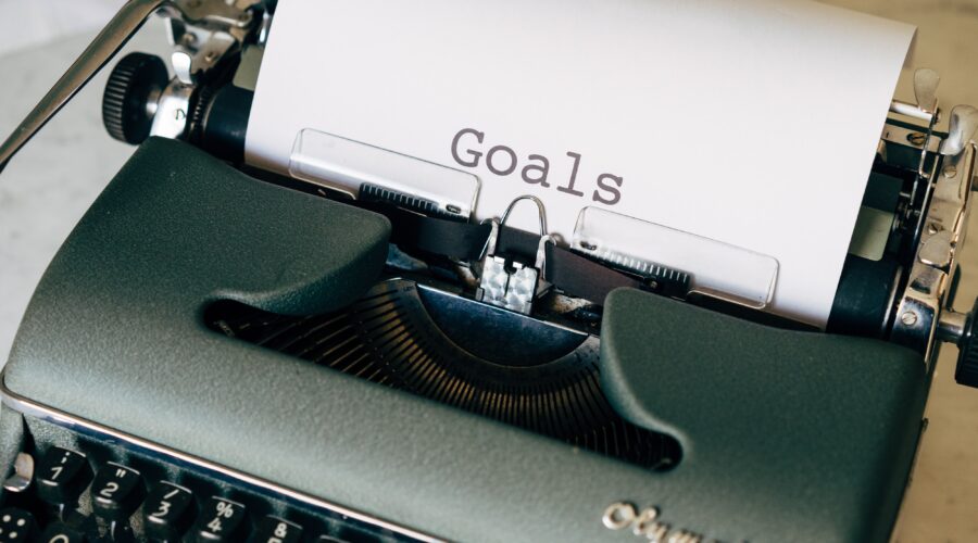 typewriter with paper that says "goals"