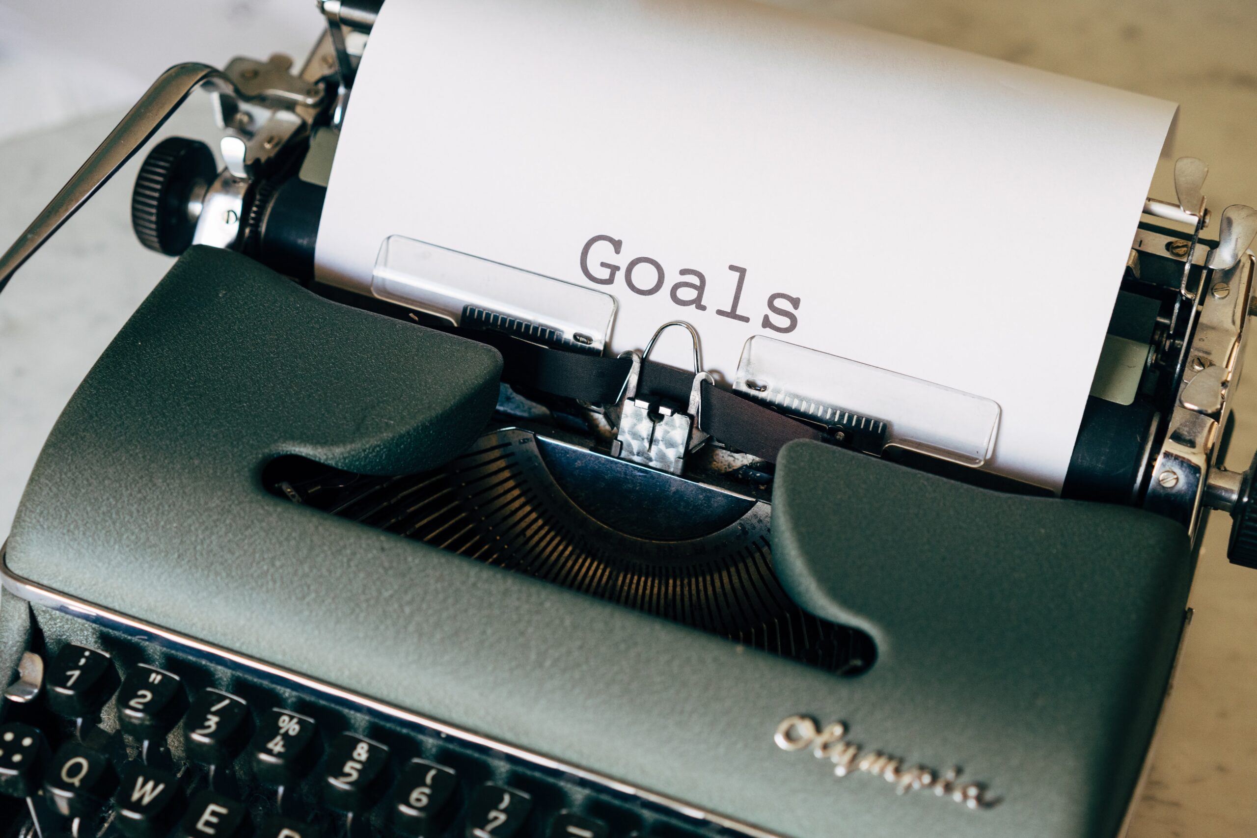 typewriter with paper that says "goals"