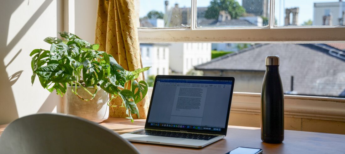 laptop set up in a home office for an online college student