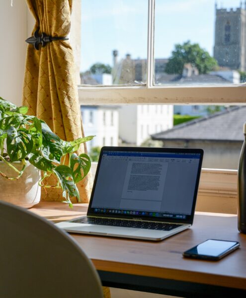 laptop set up in a home office for an online college student