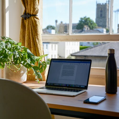 laptop set up in a home office for an online college student