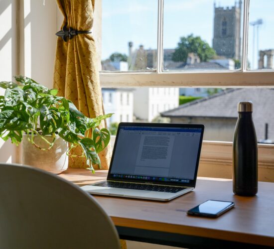 laptop set up in a home office for an online college student