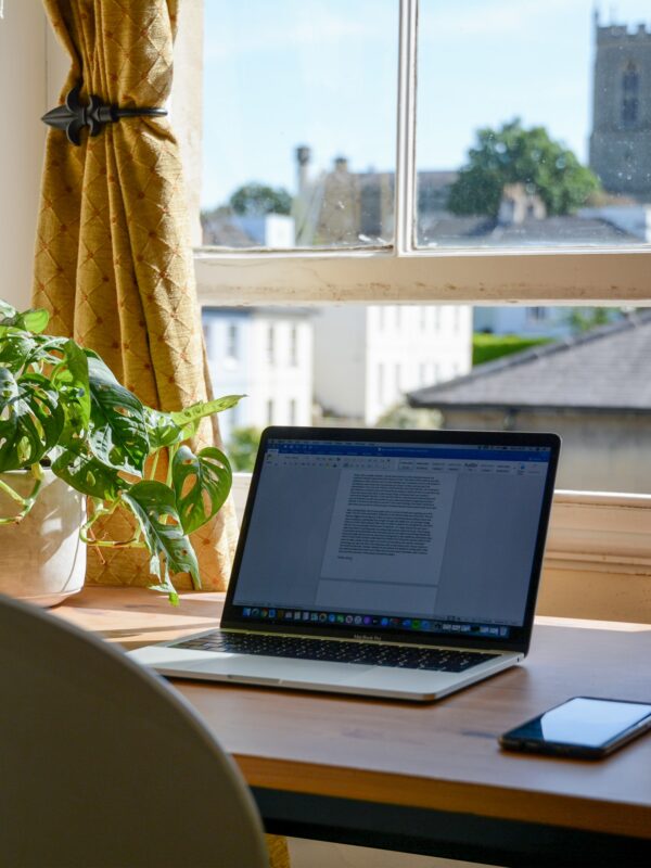 laptop set up in a home office for an online college student