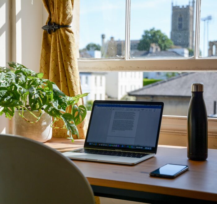 laptop set up in a home office for an online college student