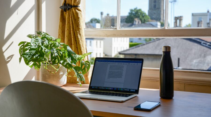 laptop set up in a home office for an online college student