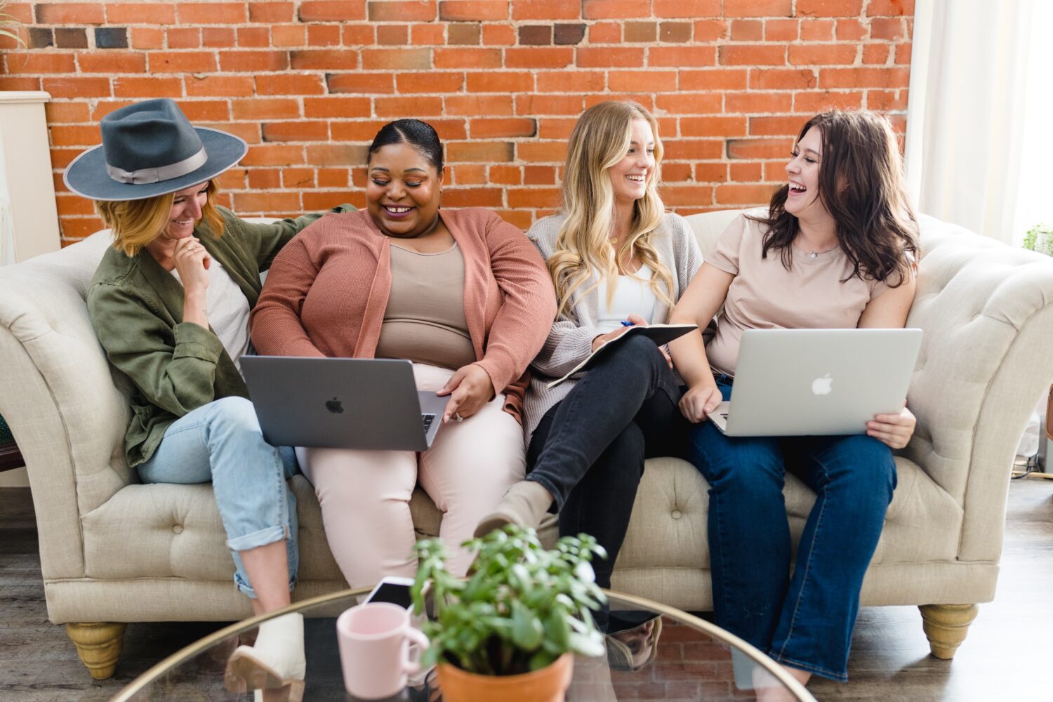 group of happy coworkers sitting together on a couch; rage applying for new jobs