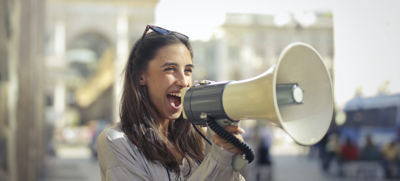 a young woman shouting into a megaphone; why bad managers are everywhere