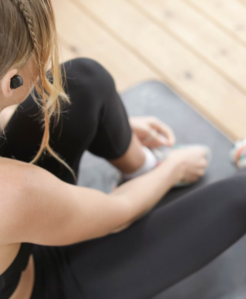 A person rests on their exercise mat during a workout.