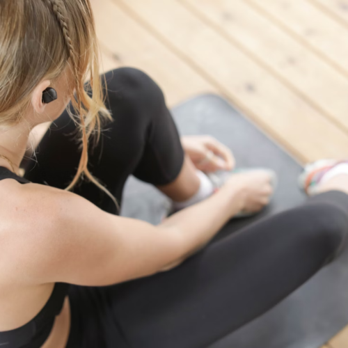 A person rests on their exercise mat during a workout.