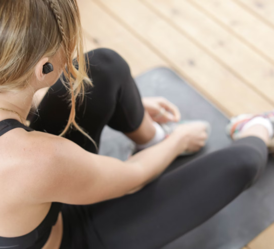 A person rests on their exercise mat during a workout.