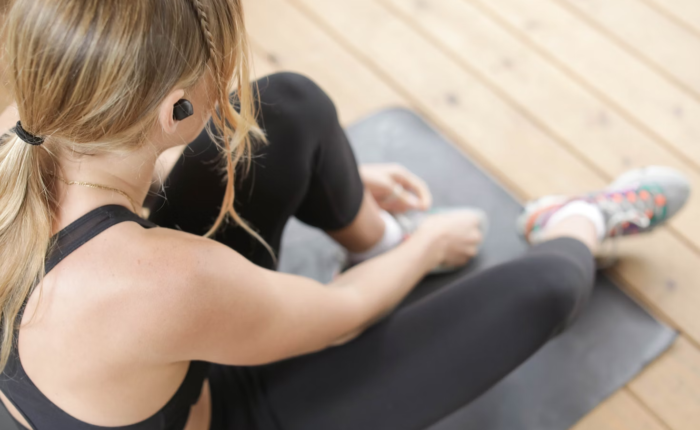 A person rests on their exercise mat during a workout.