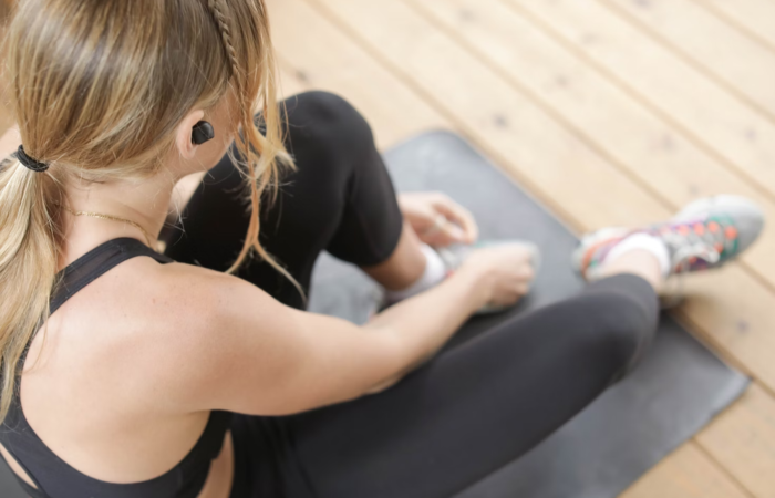 A person rests on their exercise mat during a workout.