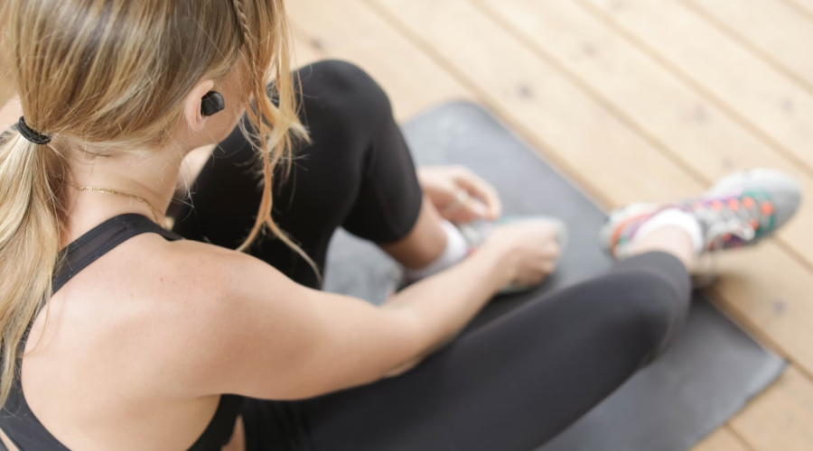 A person rests on their exercise mat during a workout.