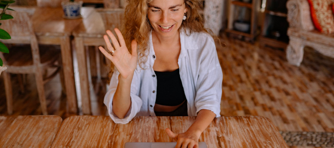 A woman takes an online class while sitting in her living room